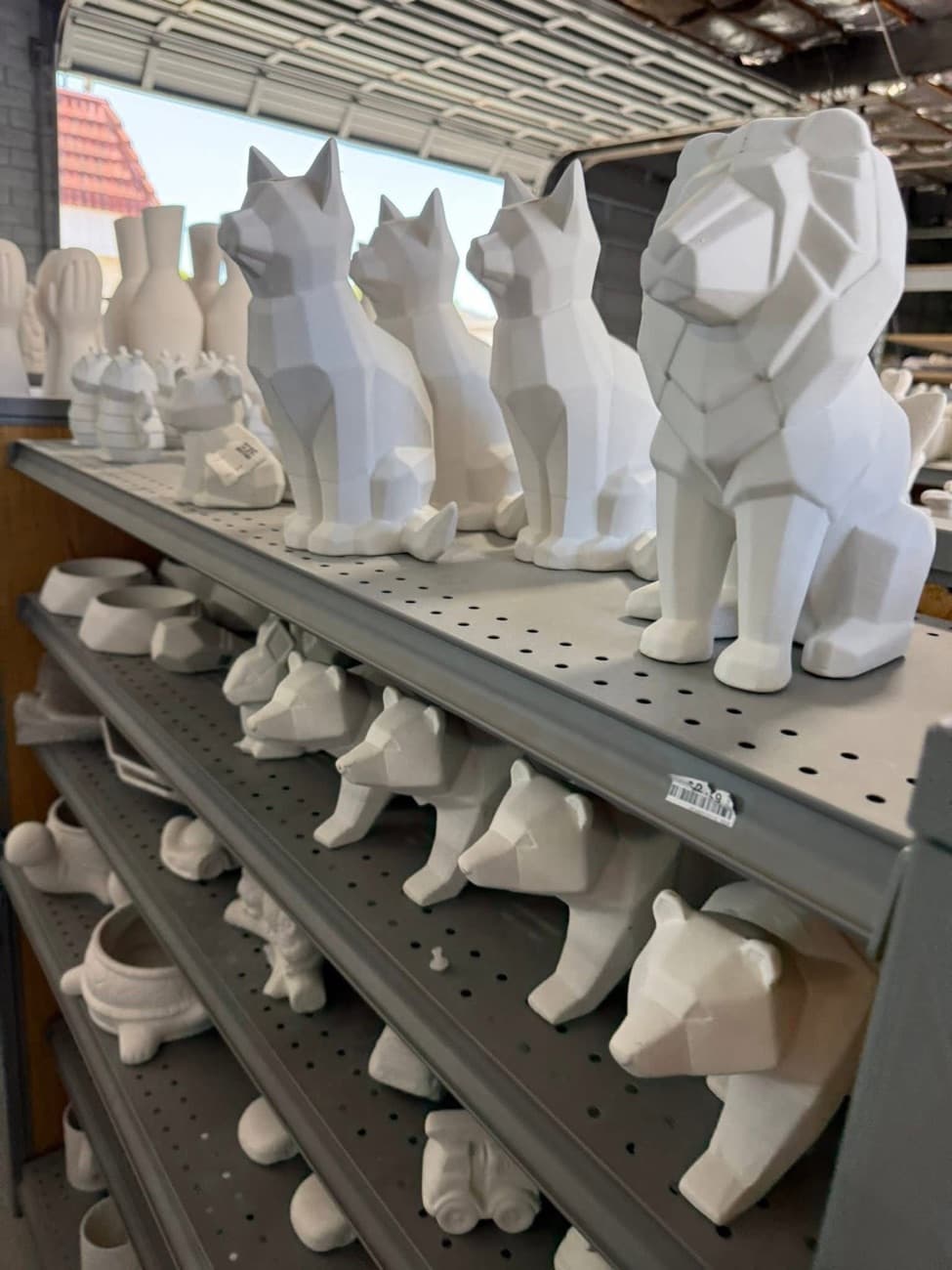 Shelves of premade bisque pieces ready to paint at Colibri Pottery Studio