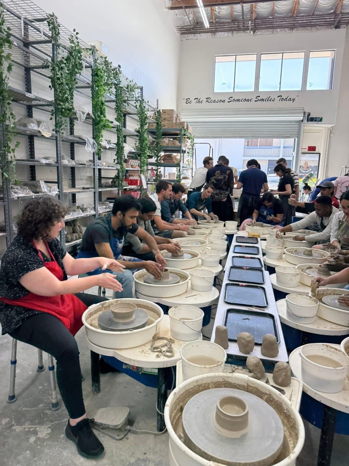 A wheel-throwing class in progress at Colibri Pottery Studio